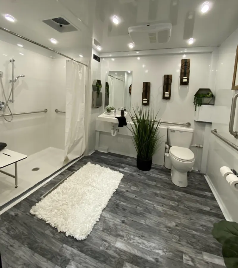 Spacious ADA restroom interior with grab bars and a vanity