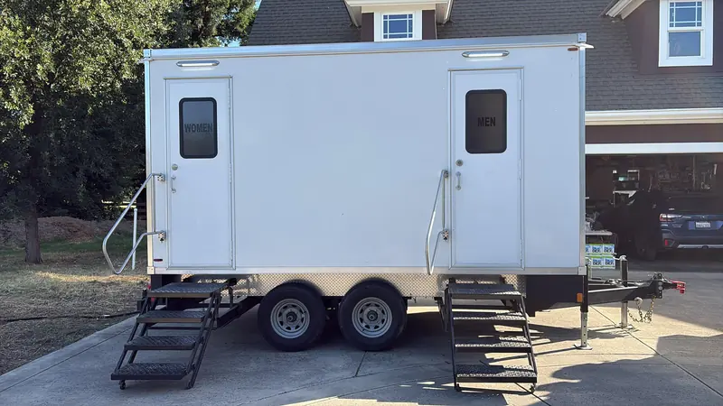 Restroom trailer on a brick driveway at a private home party