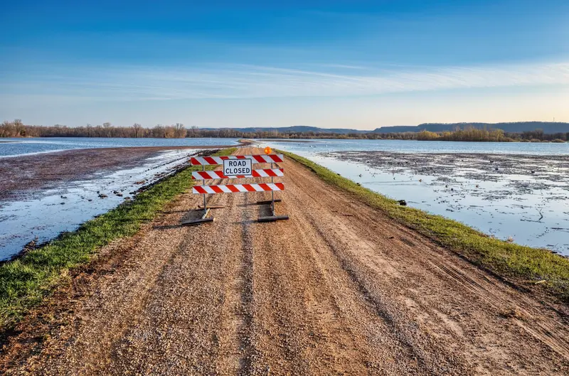 Closed levee road between flooded Delta fields